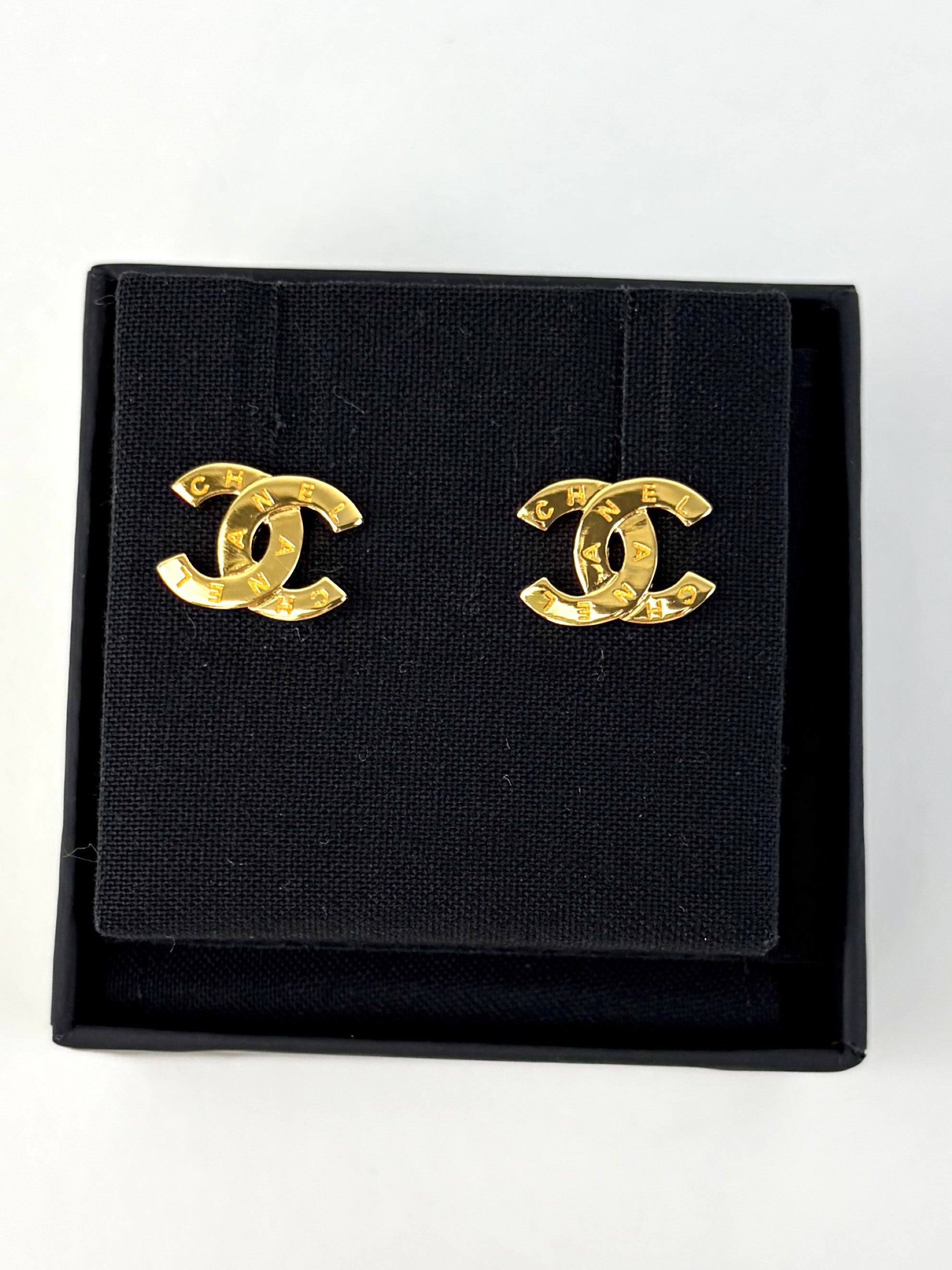 Chanel Gold metal cc Paris button stud earrings