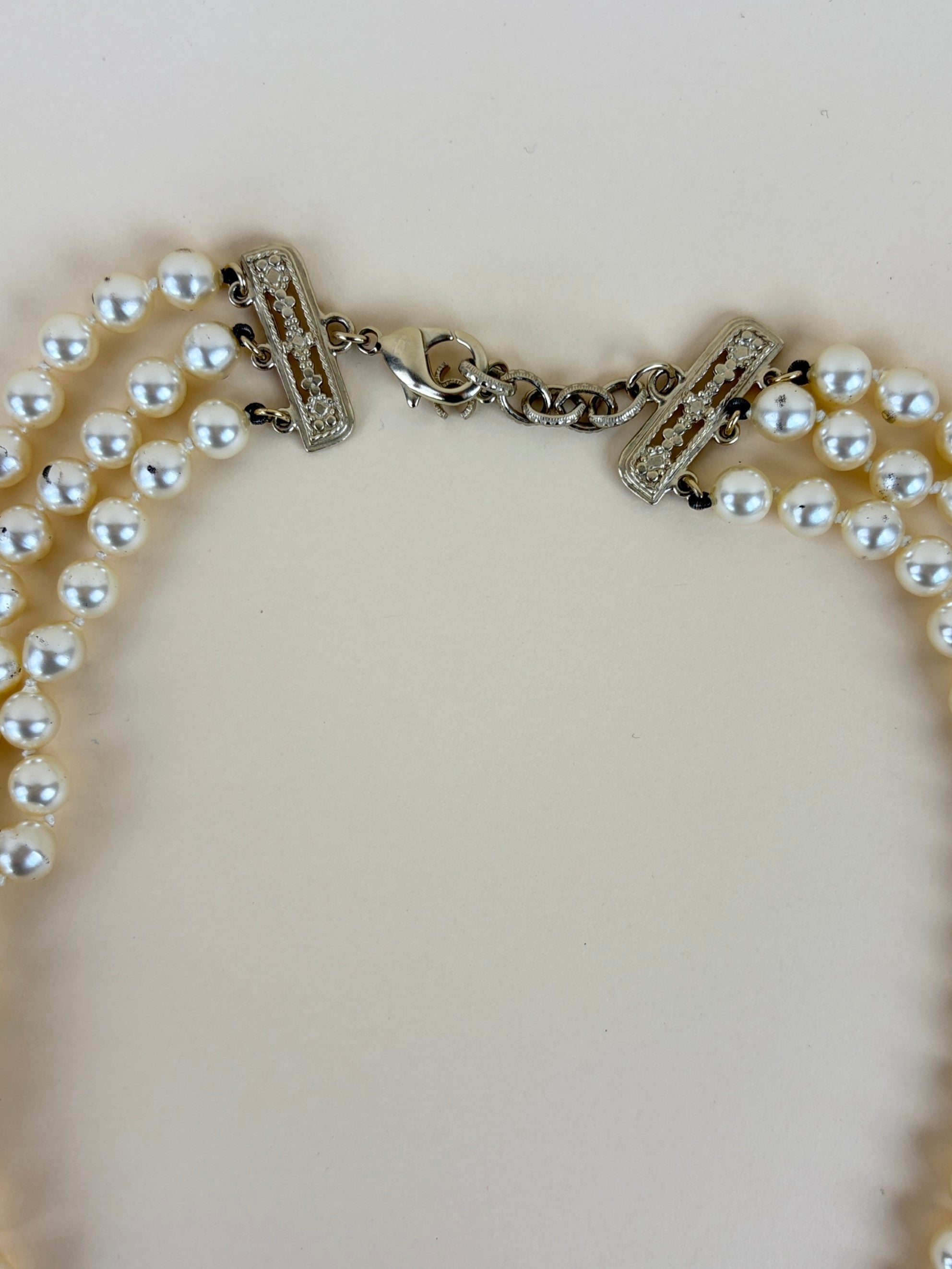 Chanel faux cc pearl multi strand necklace with a decorative emerald green and pearl clasp