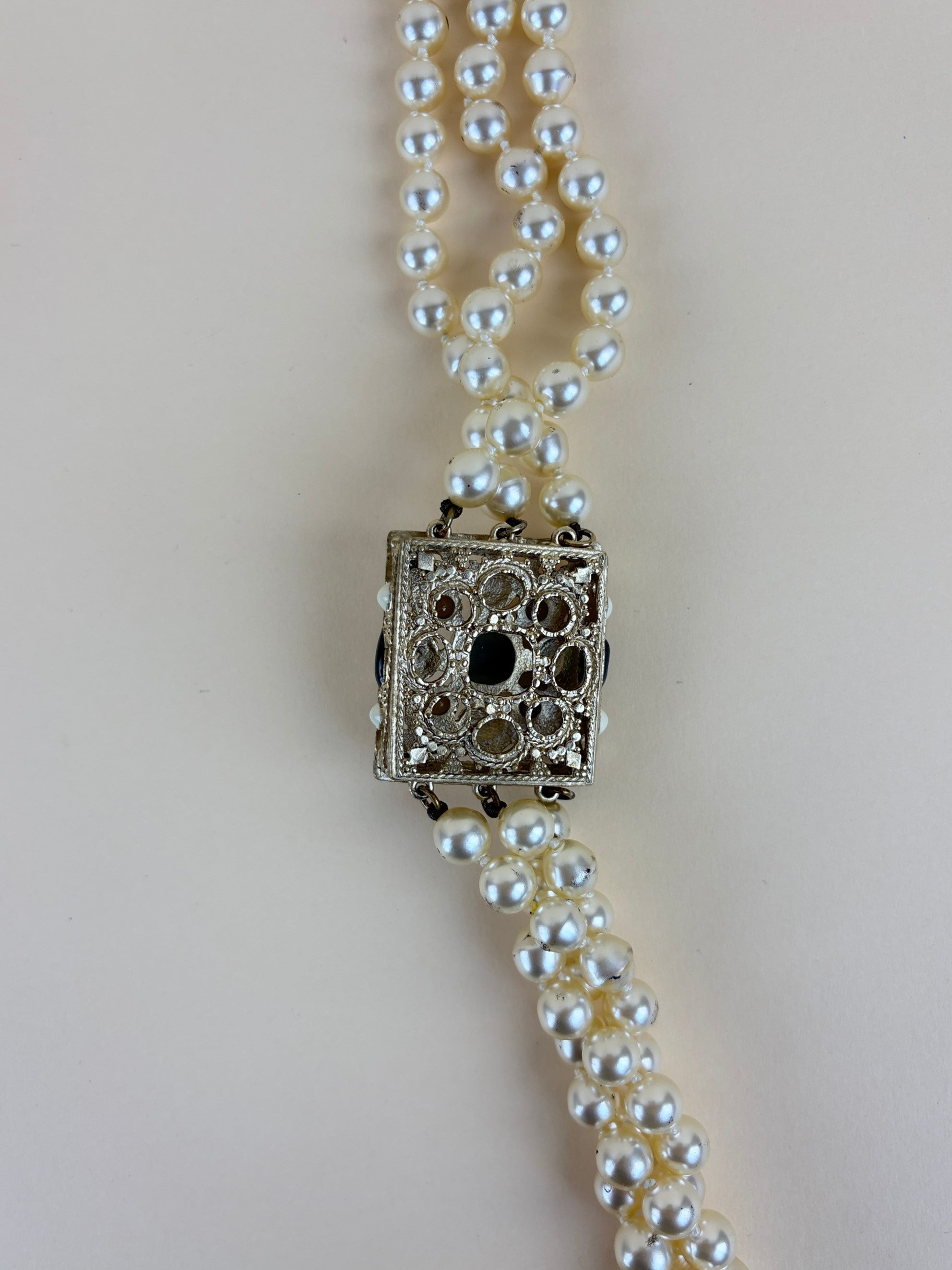 Chanel faux cc pearl multi strand necklace with a decorative emerald green and pearl clasp