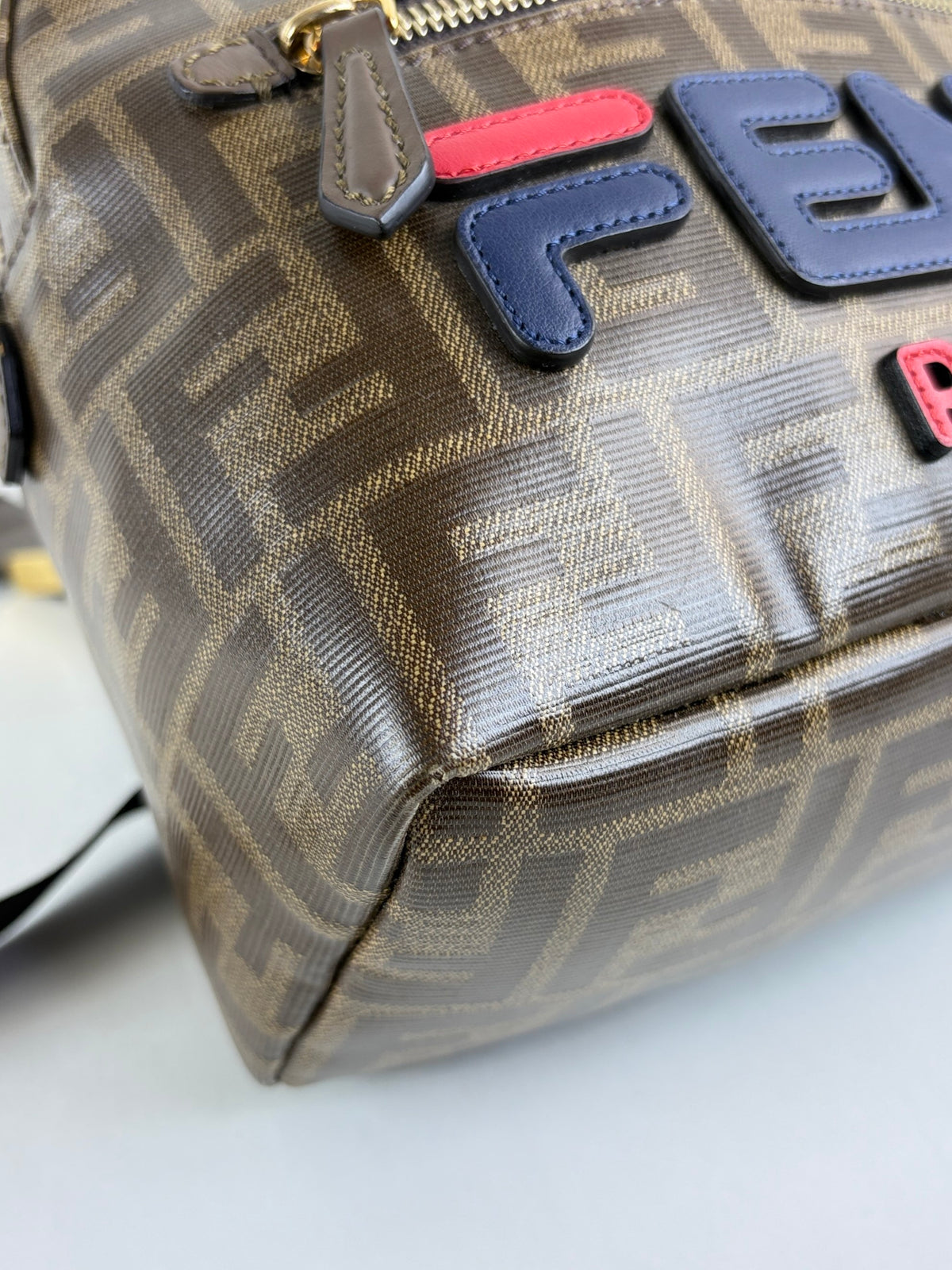 Fendi x fila glazed fabric vitello century ff 1974 mania pouch pocket backpack mogano panna blueberry