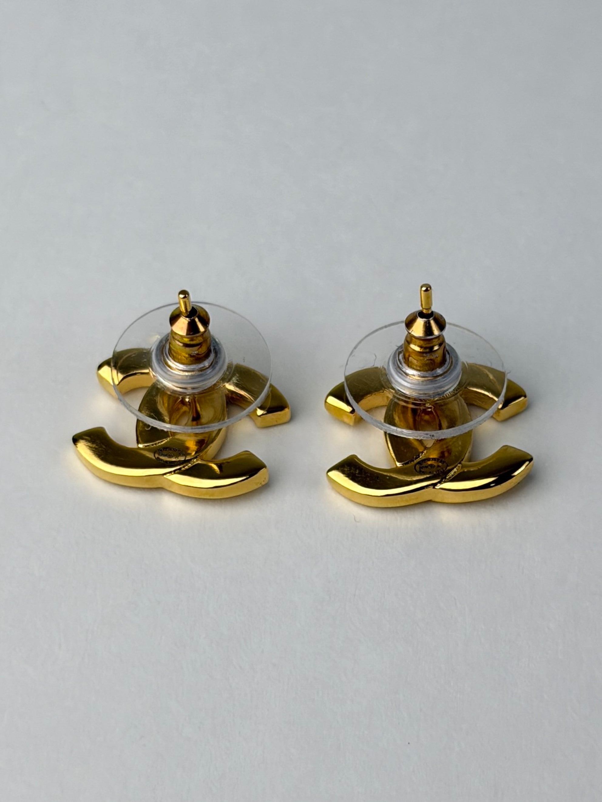 Chanel Gold metal cc Paris button stud earrings