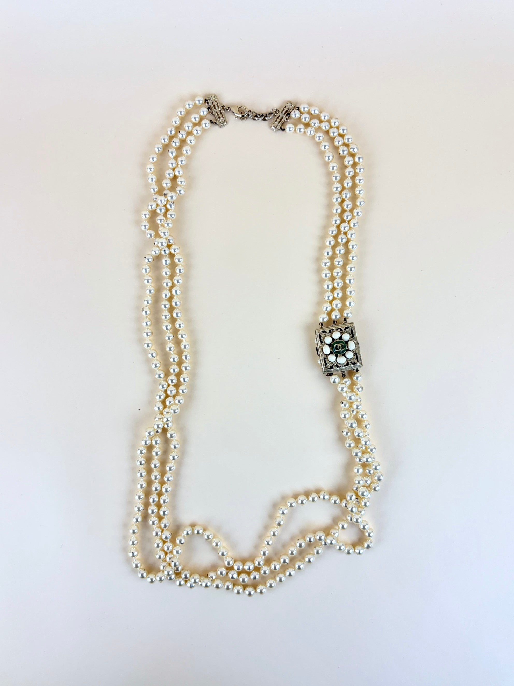 Chanel faux cc pearl multi strand necklace with a decorative emerald green and pearl clasp