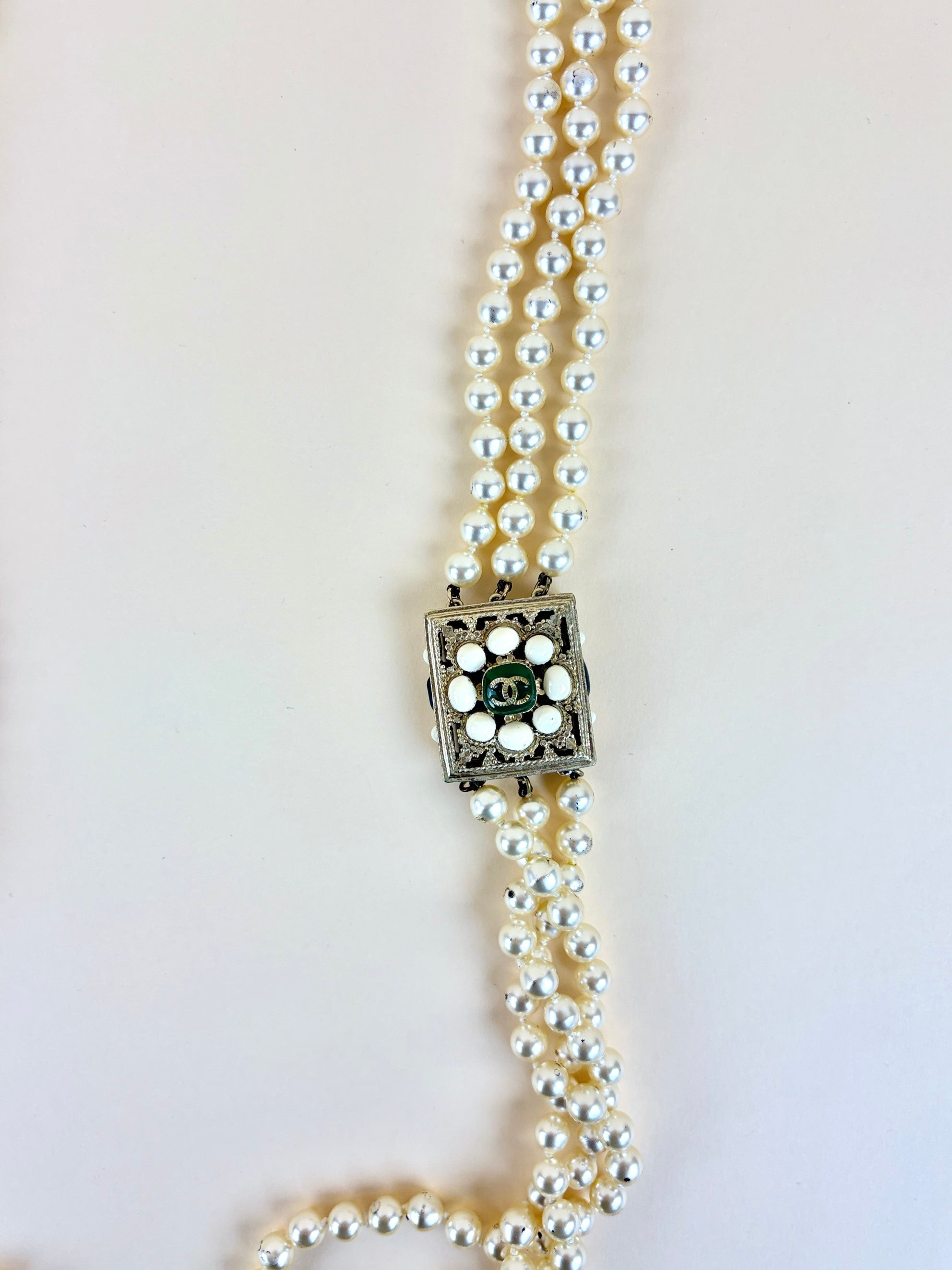 Chanel faux cc pearl multi strand necklace with a decorative emerald green and pearl clasp