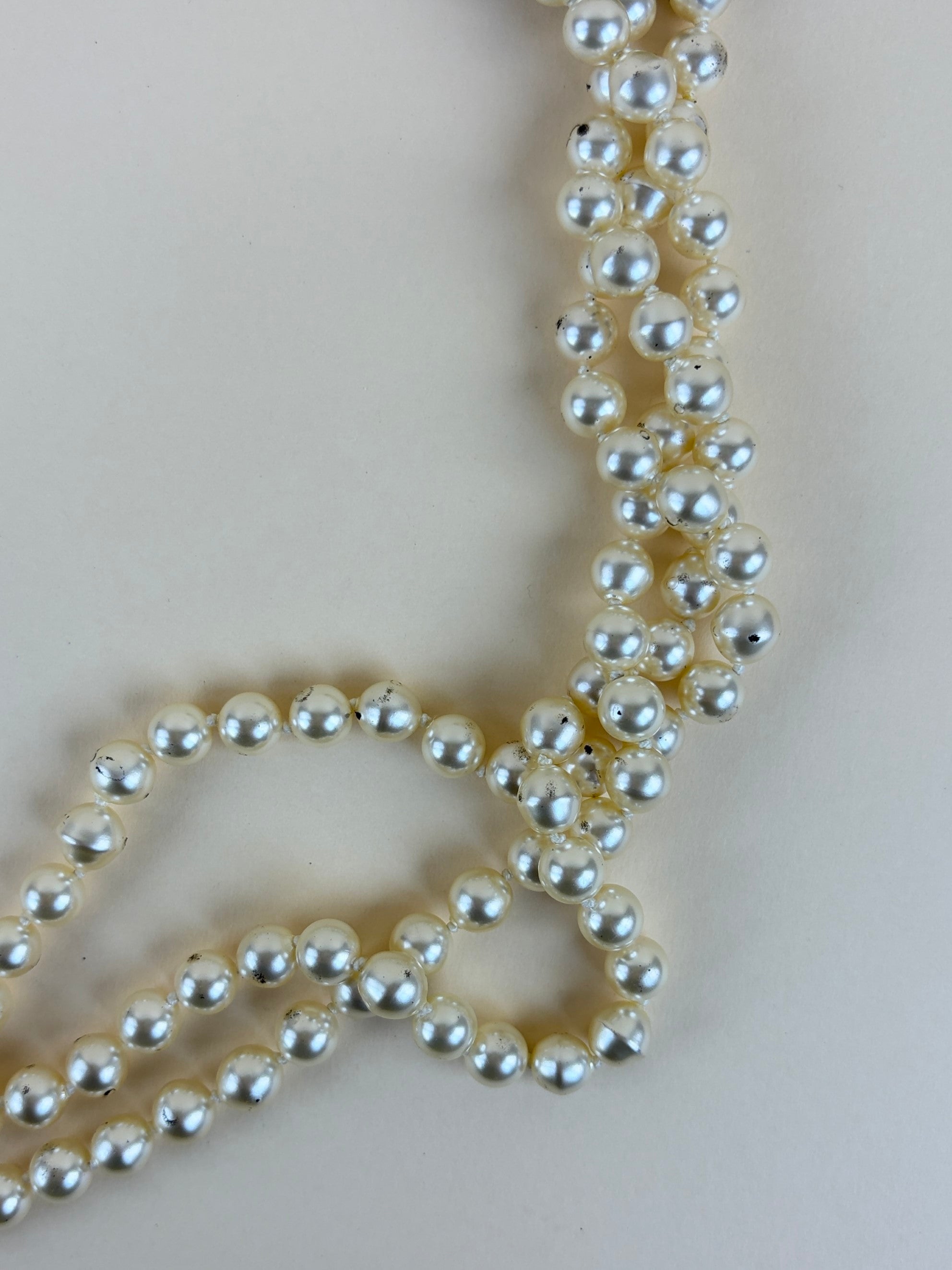 Chanel faux cc pearl multi strand necklace with a decorative emerald green and pearl clasp