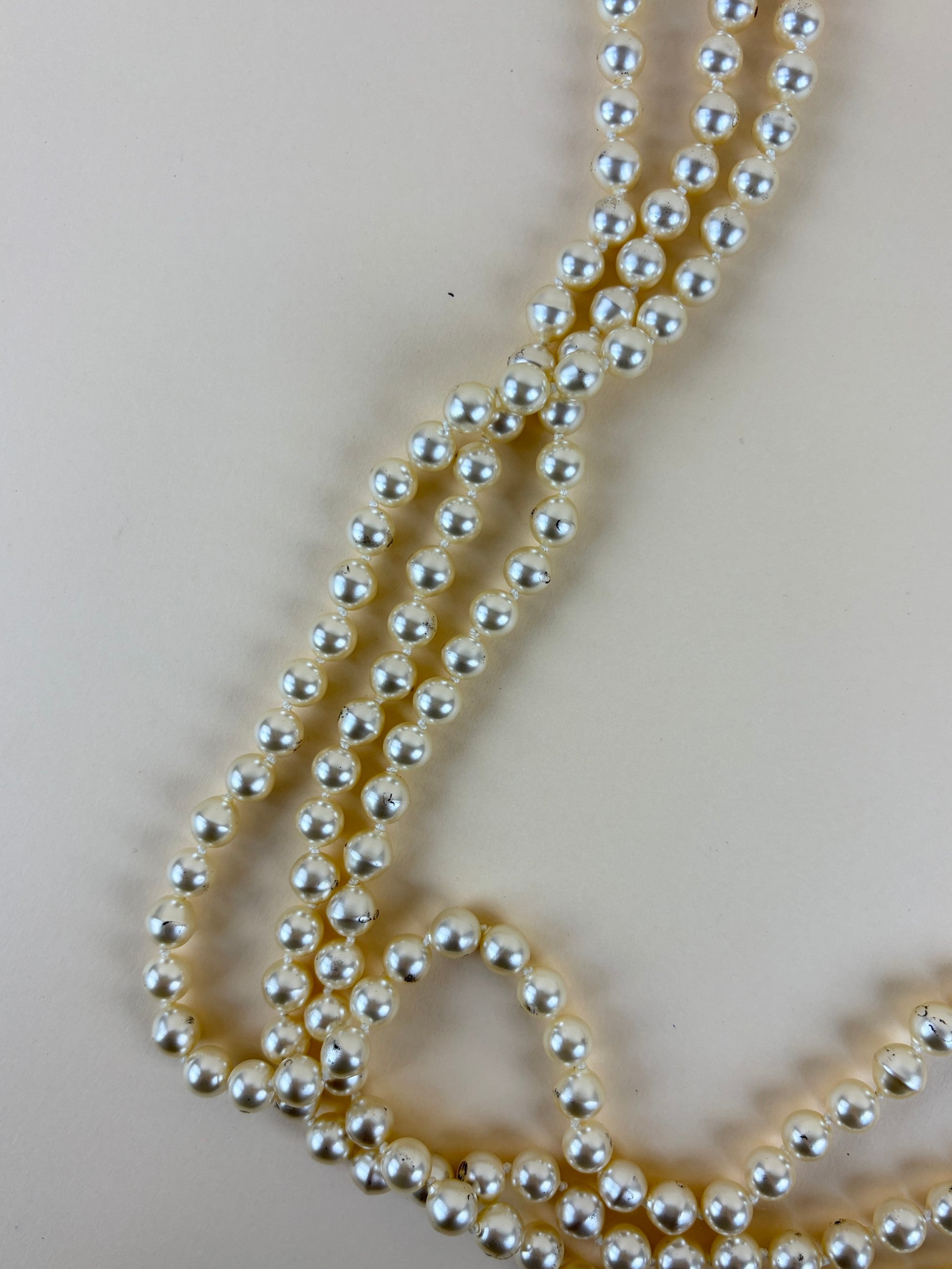 Chanel faux cc pearl multi strand necklace with a decorative emerald green and pearl clasp