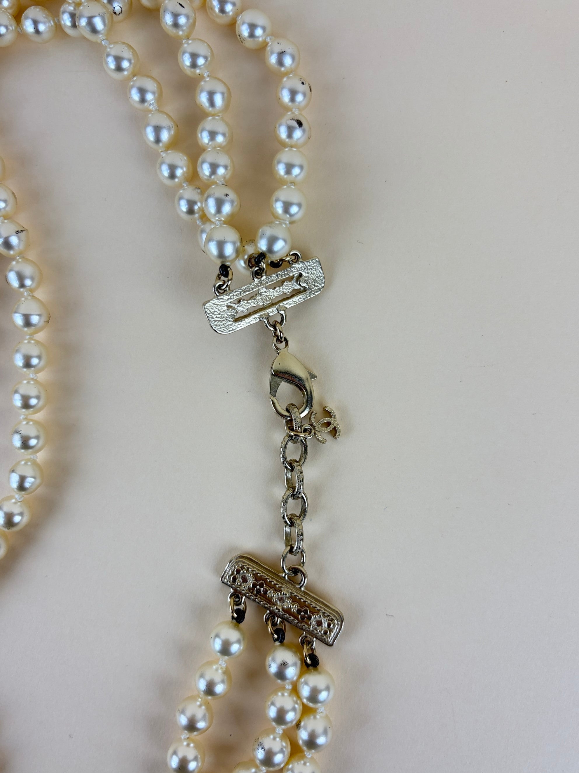 Chanel faux cc pearl multi strand necklace with a decorative emerald green and pearl clasp