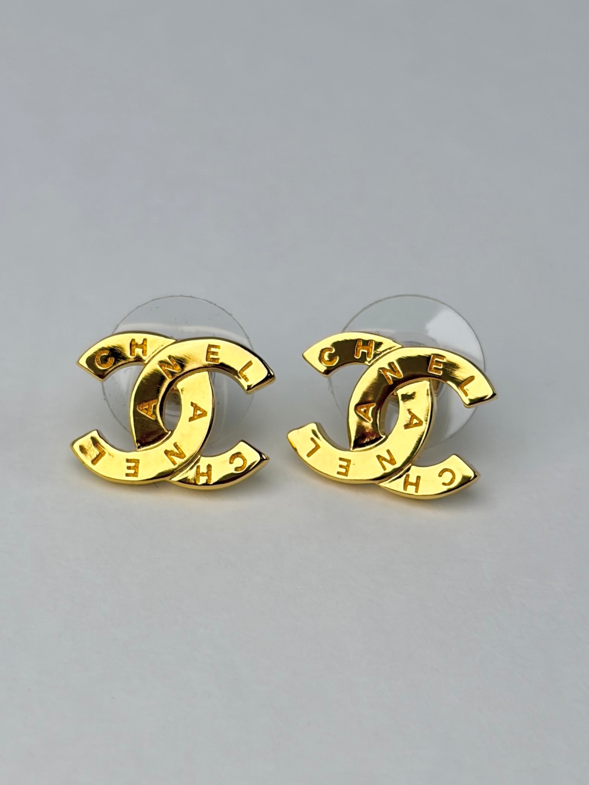 Chanel Gold metal cc Paris button stud earrings