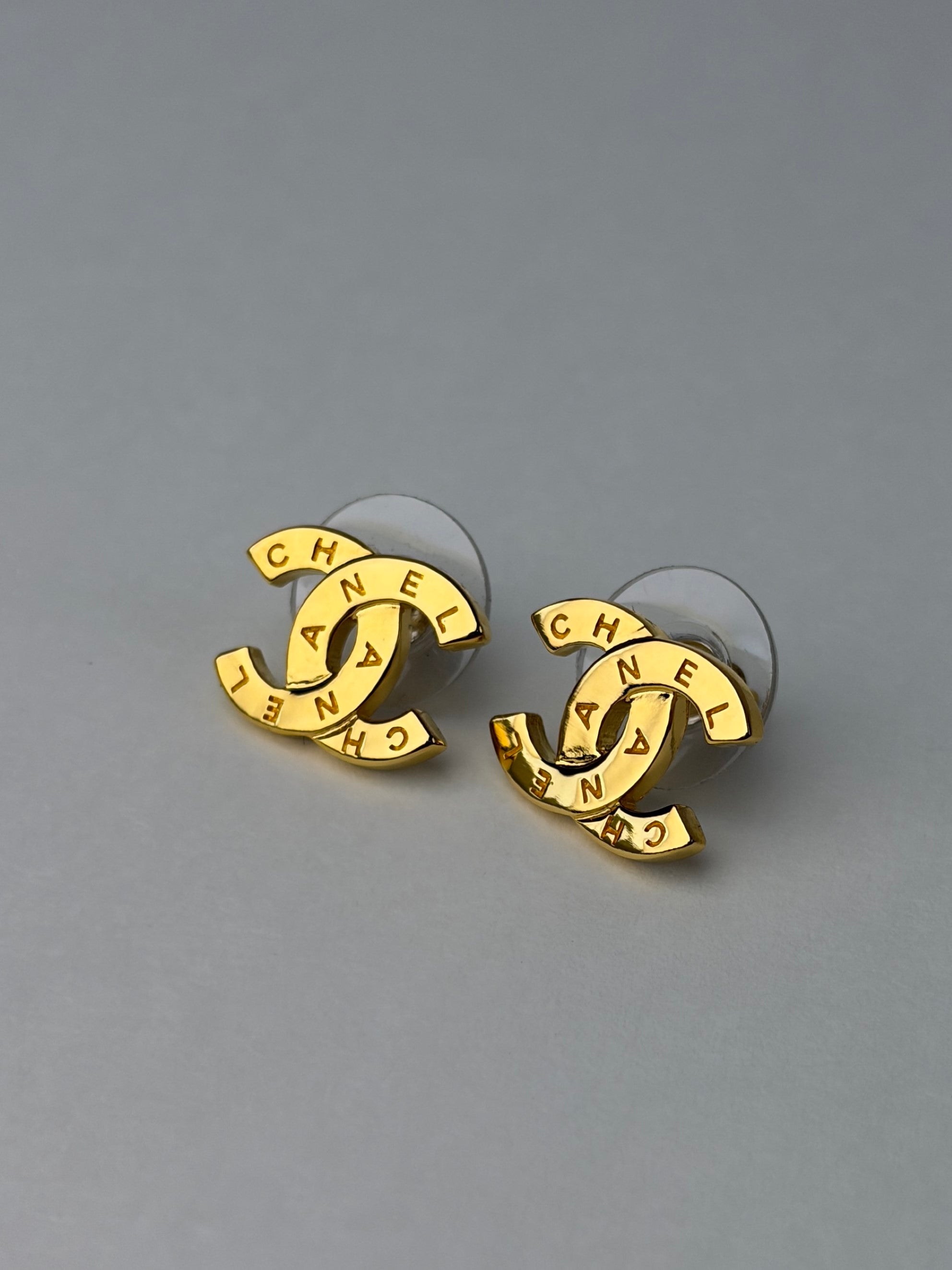 Chanel Gold metal cc Paris button stud earrings